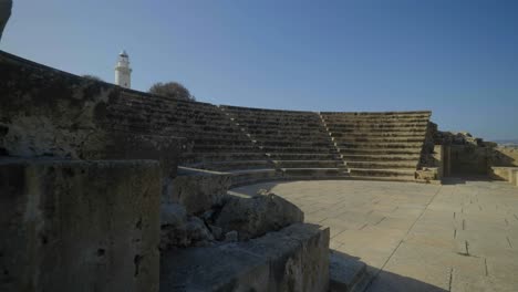 Gorgeous-view-of-traveling-towards-the-interior-of-an-ancient-Odeon-with-a-beautiful-lighthouse-in-the-background