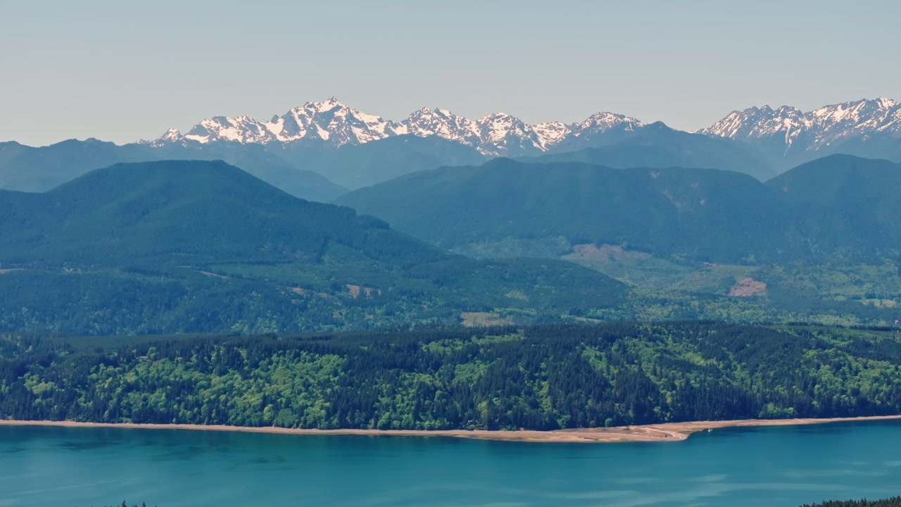 Drone view of Olympic National Park in Washington State, capturing vast forests, mountain ridges, and the wild natural landscape of the Pacific Northwest from above.