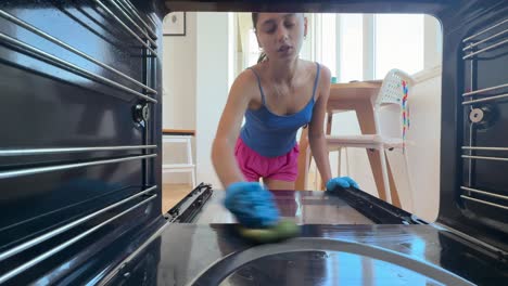 woman cleaning oven