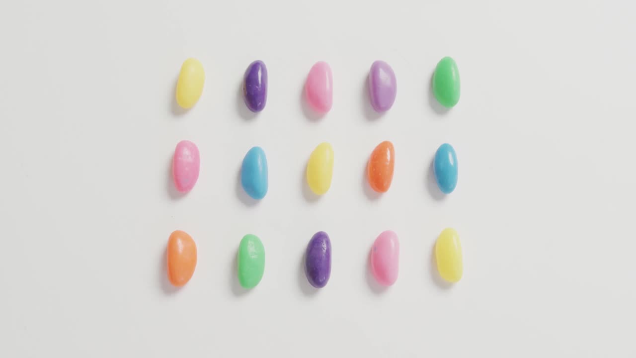 video de vista aérea de filas de dulces multicolores sobre un fondo blanco