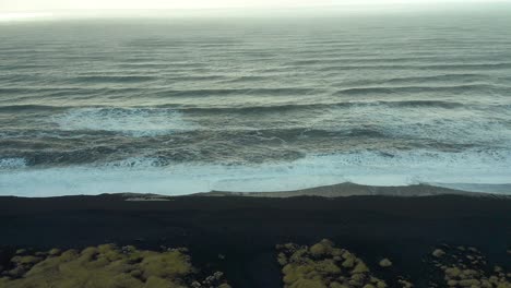 waterfront seascape in a black sand cursed beach, iceland terrifying destination