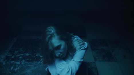 woman in a blue-lit room