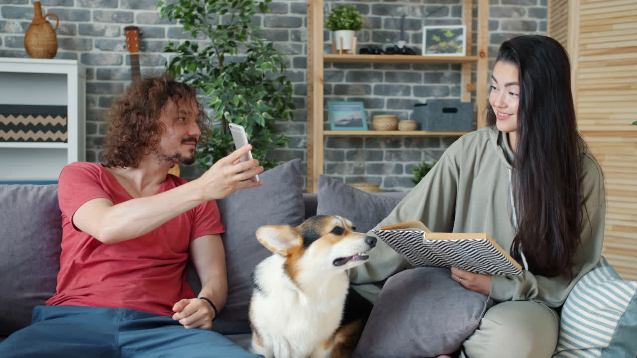 Couple relaxing at home with a dog