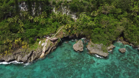 aerial pullout away from jokin's cliffs and bay in lifou, new caledonia