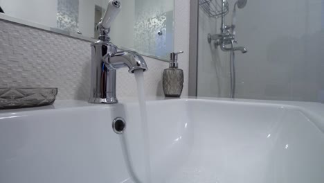 water running in a modern bathroom sink