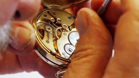 horologist repairing a pocket watch