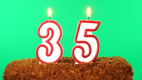 cake with the number 35 lighted candle. chroma key. green screen. isolated