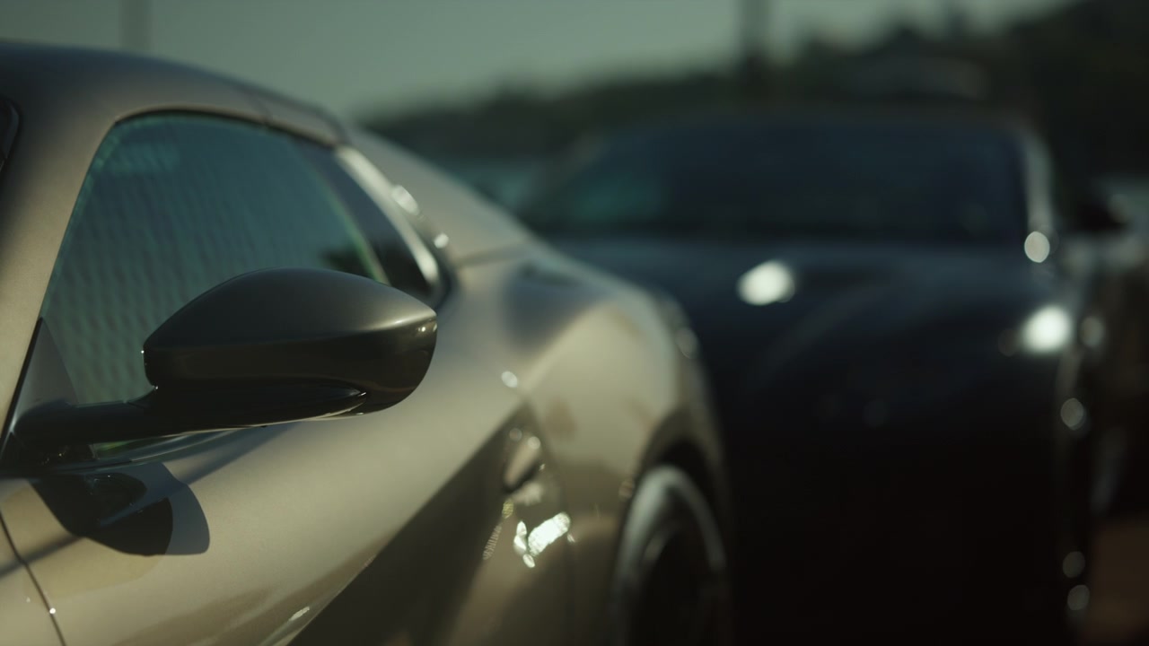Grey sport car side a mirror reflecting the background details. Modern automotive design showcasing vehicle luxury and style