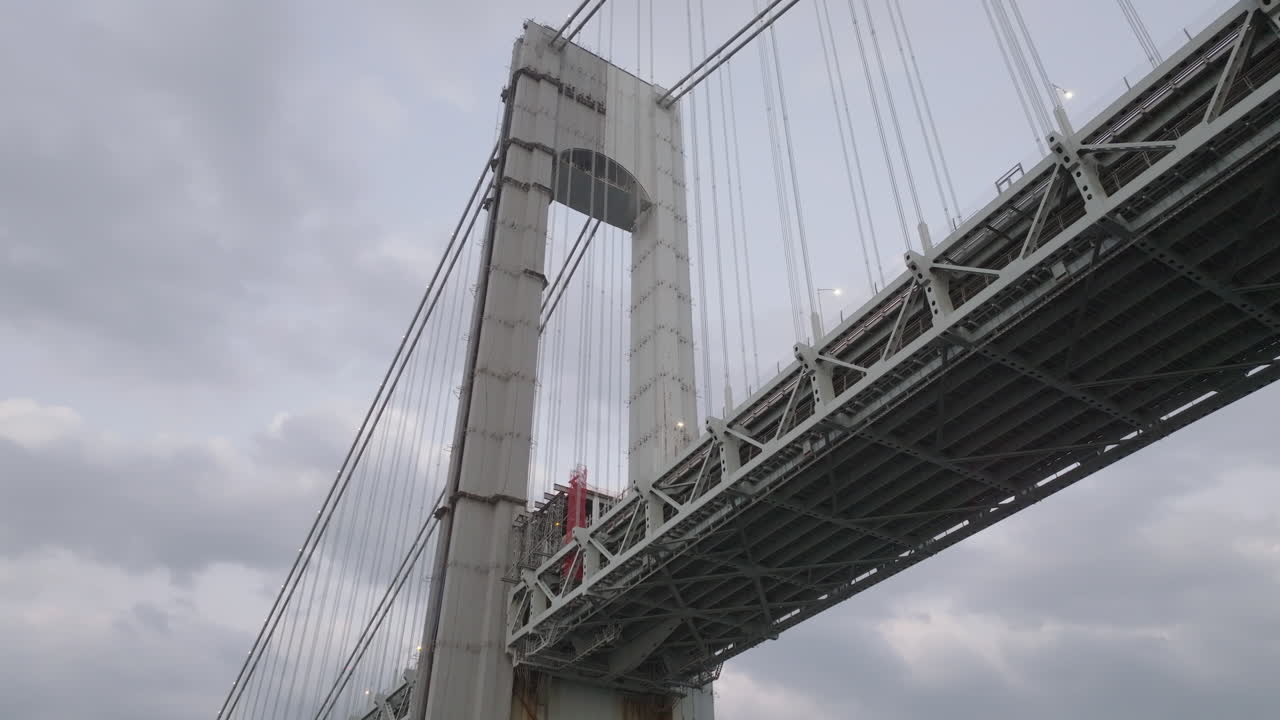 Drone shot looking up at the Verrazzano-Narrows Bridge on an overcast day. Shot in New York City