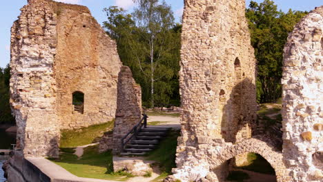 the ruins of castle kokneses pildrupas, latvia are shot as a close-up. the castle is based near the water.