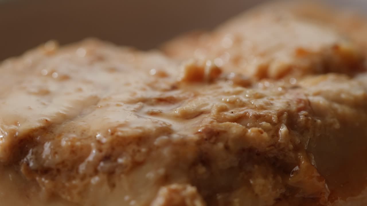 Smoked cod liver in oil in open tin can with fresh greens on wooden table. Seafoods delicacy. High quality 4k footage