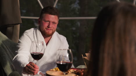 couple enjoying wine and dinner outdoors