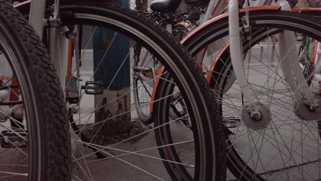 bicycle chained and parked on sidewalk, close up detail of bike tires