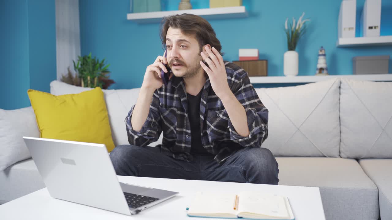 Home office worker's business is going badly. Negative phone call.