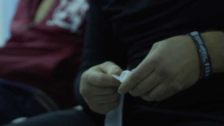 Person wrapping hands with bandages