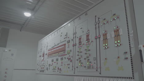 switch controls on metal panel in production facility line showing push buttons and switches - emergency stop at factory, plant - close up. industrial, electronic, technology equipment concept