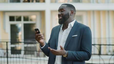 Confident-male-professional-having-video-chat-outside.-Man-standing-outdoors