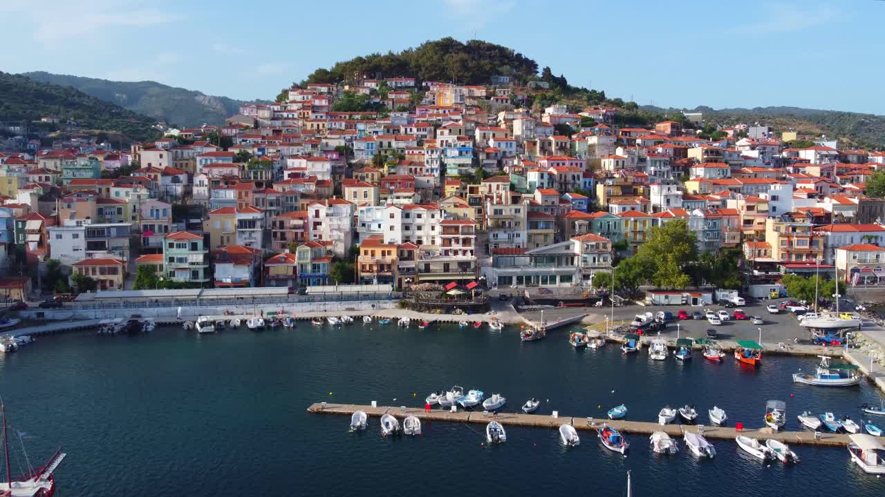 Beautiful Plomari town seaside villas, busy port in Lesbos island surrounded by mountains and Aegean sea, East Mediterranean, Aerial view, closeup