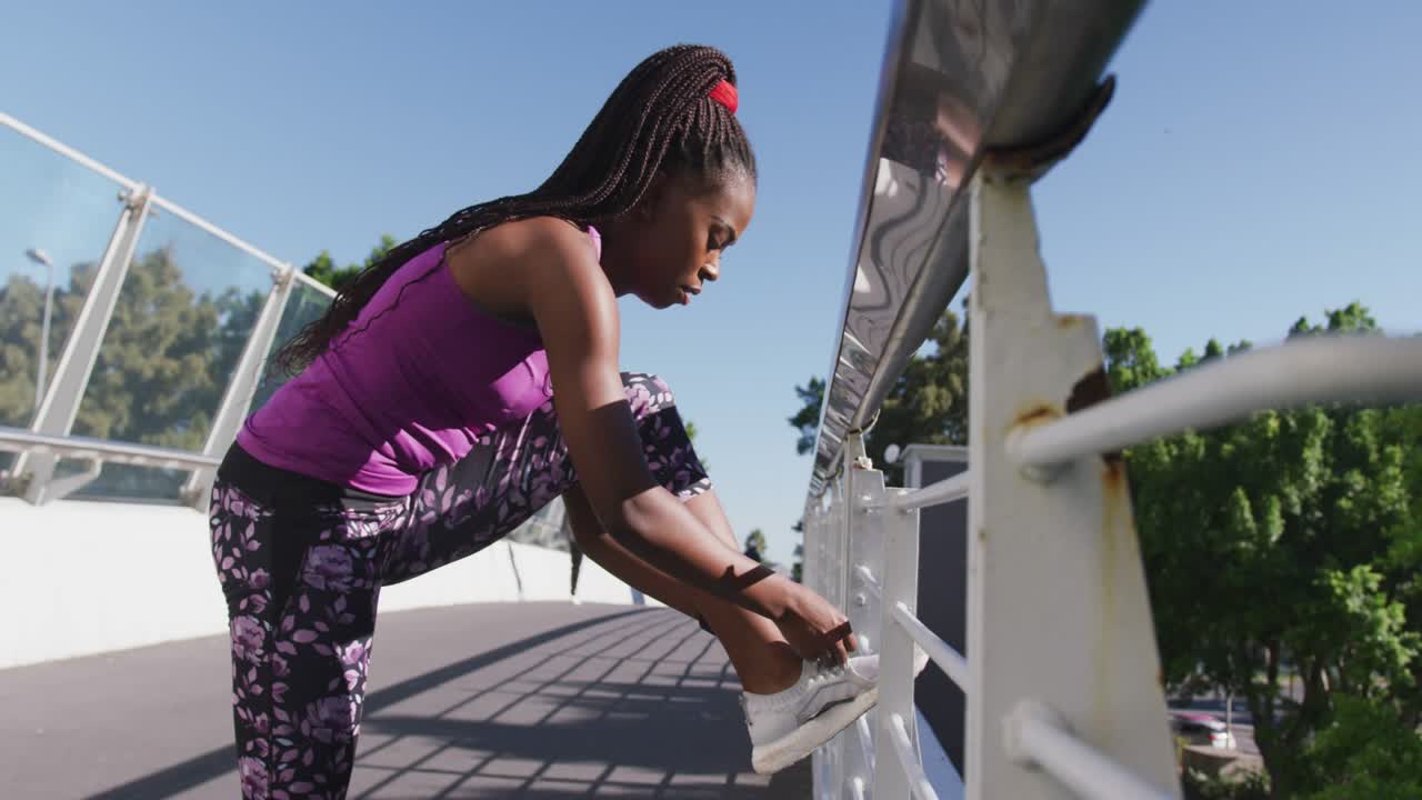 Woman placing foot on railing and tying sneaker for fitness promo, pink NEW COLLECTION text growing