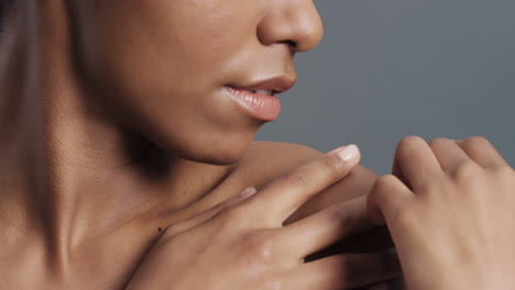 close-up-portrait-beautiful-african-american-woman-touching-bare-shoulders-with-hands-enjoying-smooth-healthy-skin-complexion-perfect-natural-beauty-on-grey-background