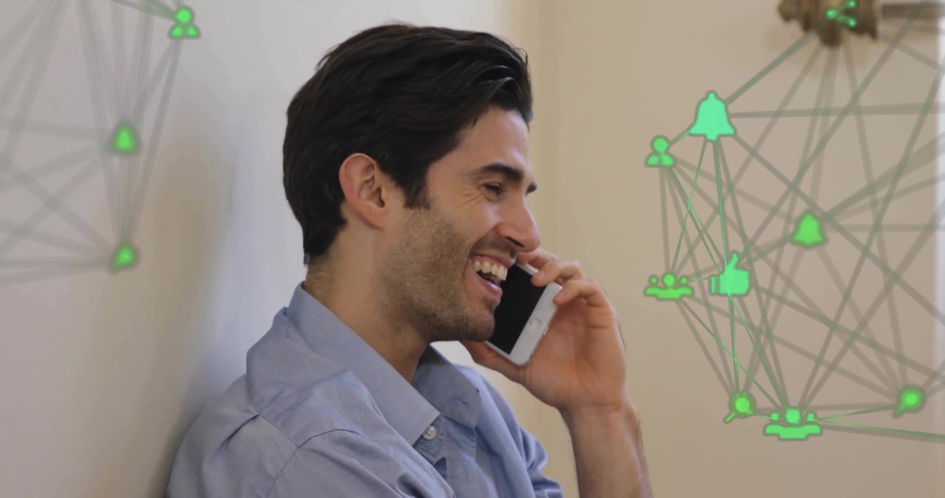 Animation of connected icons forming globes over smiling caucasian man talking using cellphone