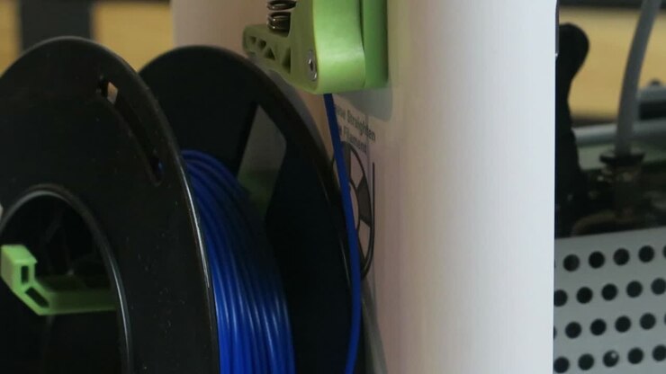 3d printer filament and printer printing a 3d model