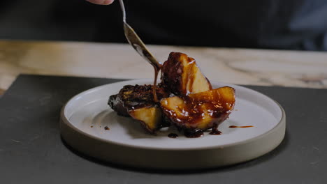 slow motion shot of a chef plating a gourmet sweet potato dish in a restaurant