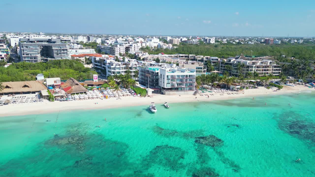 Beachfront hotels and turquoise sea in Playa del Carmen, Mexico, sunny aerial view