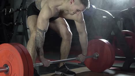 athlete in tattoo prepares for deadlift