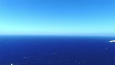 aerial 4k blue sea and sky top view over akrotiri lighthouse in santorini greece