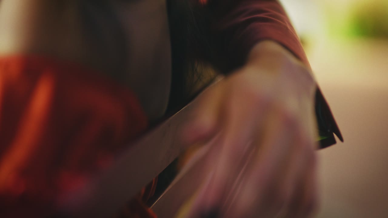 Close-up of woman's hand and red dress