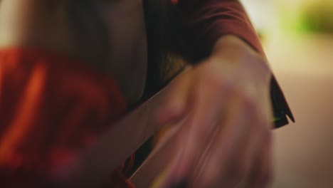 close-up of woman's hand and red dress