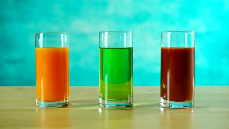 stop motion orange, apple and tomato juices filling and emptying glasses.