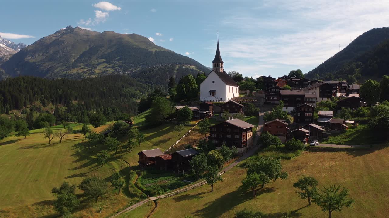 Serene aerial view of a picturesque village surrounded by lush green mountains