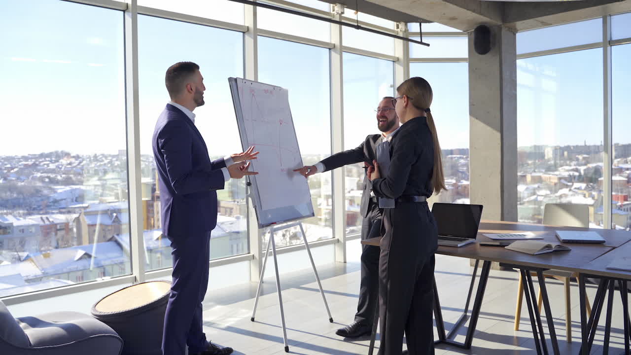 Positive business partners speaking. Teamwork of entrepreneurs in suits having a joyful conversation in office centre in the city.
