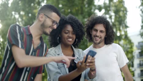 Smiling-friends-posing-for-self-portrait-in-park