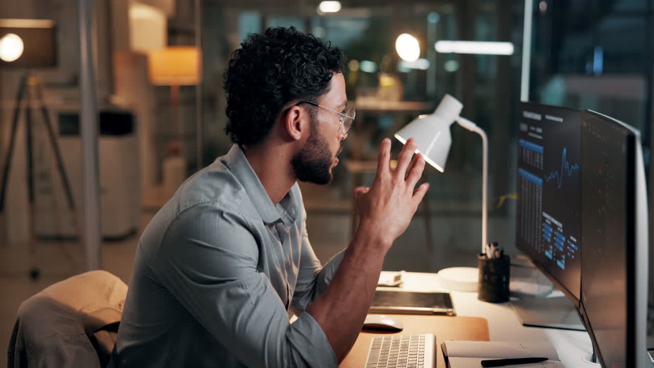 Focused Man Analyzing Data on Computer in Modern Office