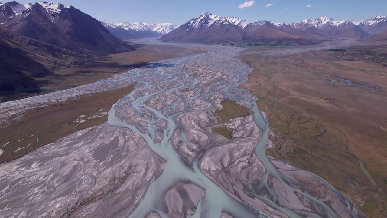 aerial flying over the braided Godley river looking towards the snow capped mountains close to lake tekapo in Canterbury New Zealand part 2