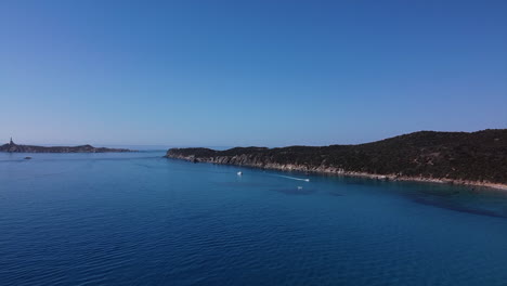 drone view of calm and silent sea with yacht and ships sailing in italy during bright day with a clear blue sky