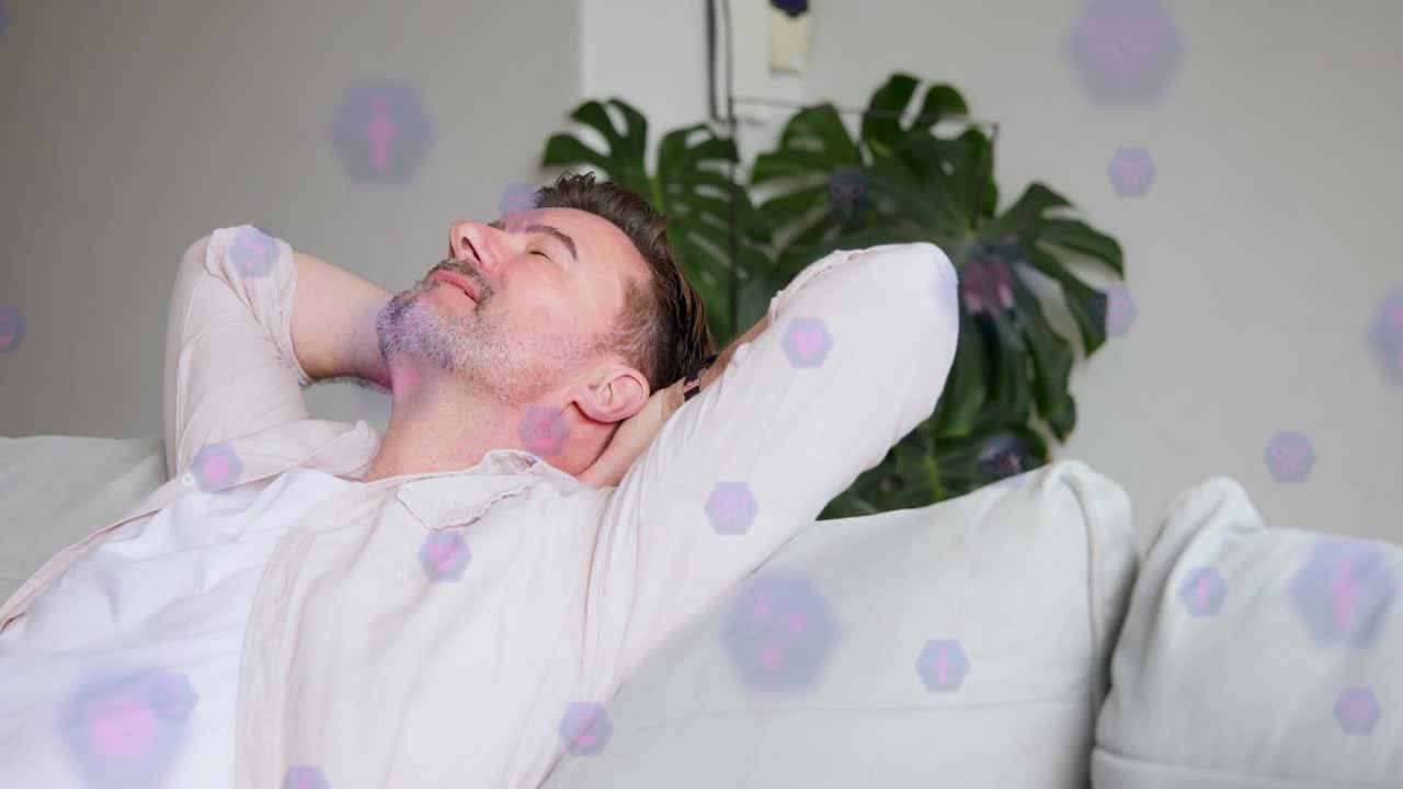 Man reclining sofa hands behind head, starting purple hex icons drifting in front fading for health