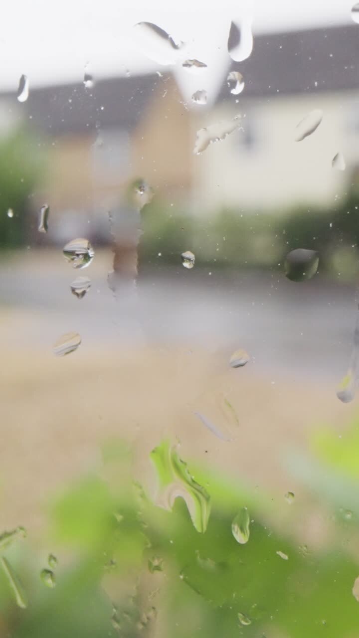 Vertical Video Looking Out Of Window Through Rain To Urban Residential Street