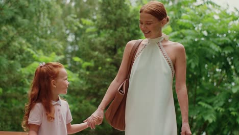 mother and daughter walking in the park