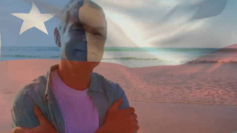 animation of flag of chile over happy senior caucasian man on beach