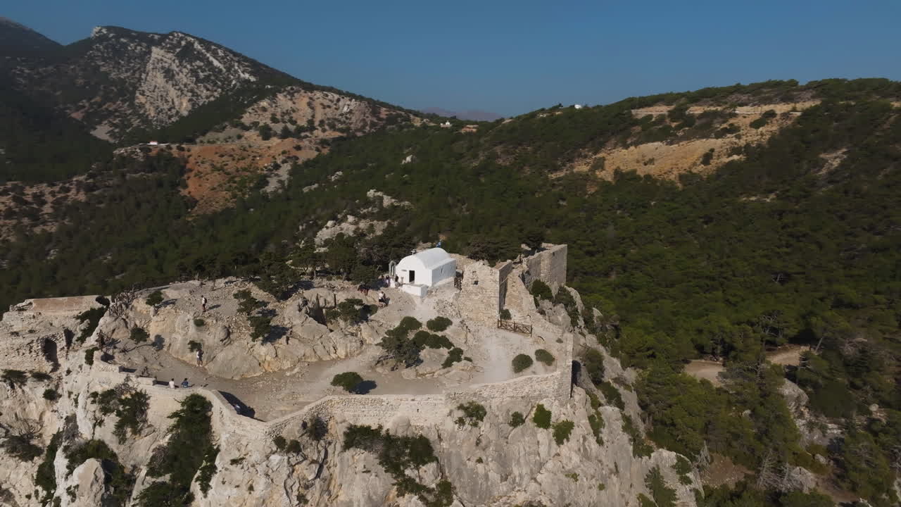 Aerial view orbiting the Castle of Monolithos, summer day in Rhodes, Greece