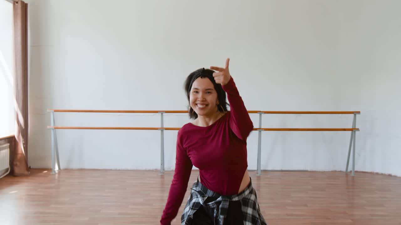 Energetic Woman Dancing in a Studio