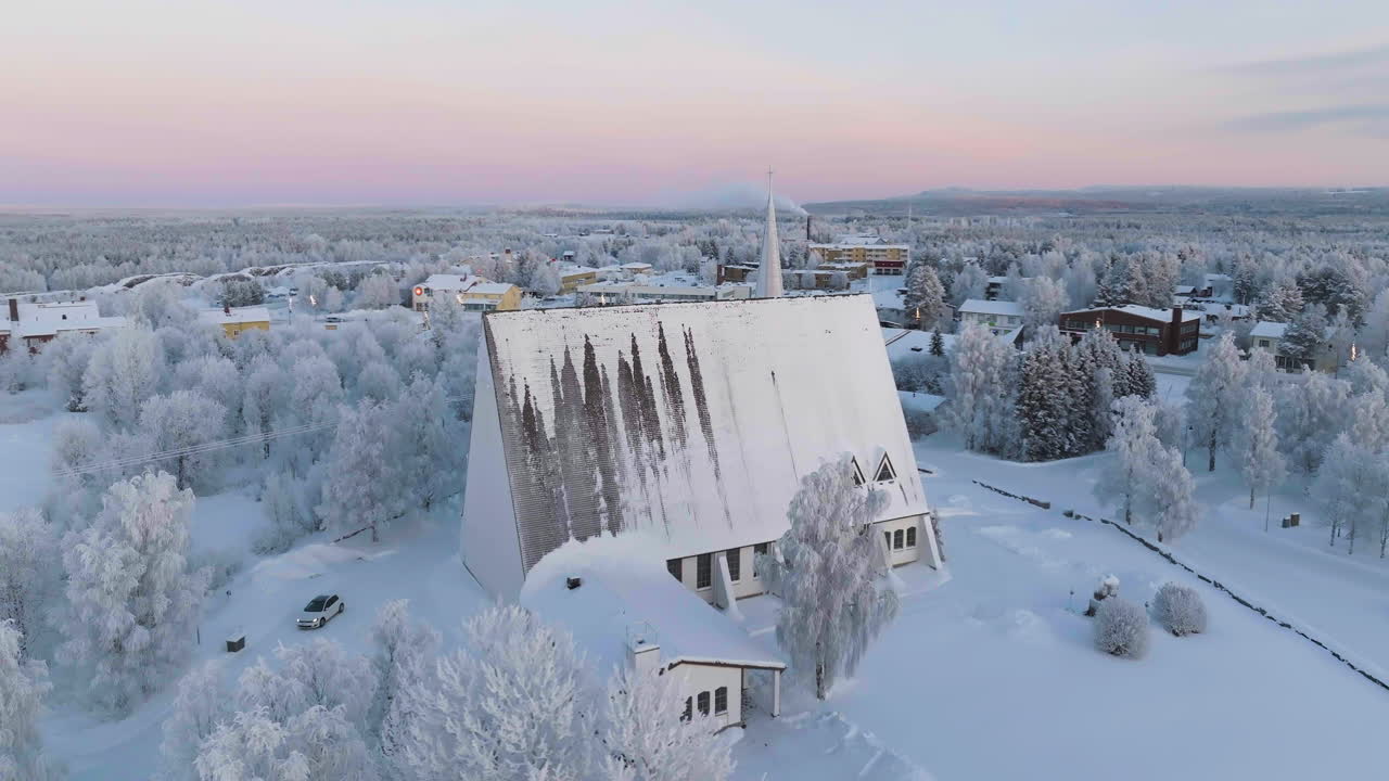 Aerial view orbiting the frosty church of Salla, polar night n Lapland, Finland
