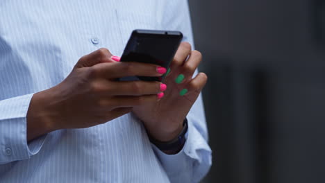 female hand holding phone swiping closeup. young application user check messages