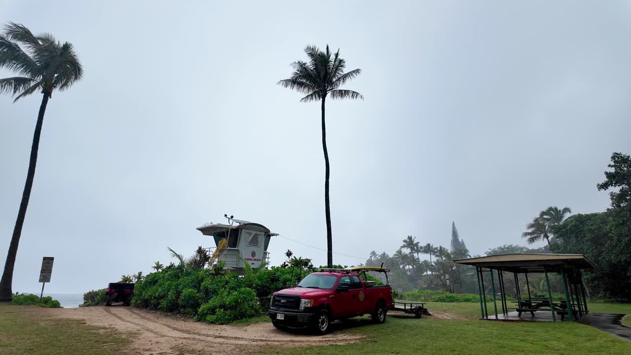 Haena Beach Park panoramic view with plam trees, on the North Shore of Kauai, Hawaii on a cloudy rainy day, popular snorkeling spot, Na Pali Coast in the background. Green lush garden island kauai