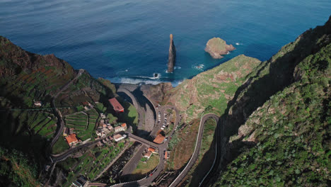 aerial view of coastal village and winding road in madeira, portugal