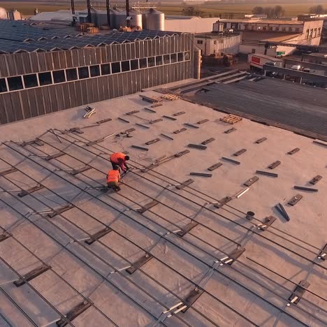workers installing solar panels on roof